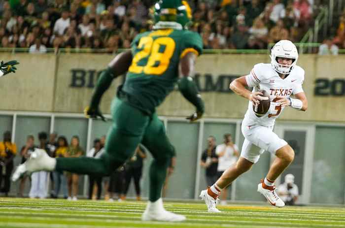 Texas Longhorns quarterback Quinn Ewers (3) runs during their game against the Baylor Bears at McLane Stadium Saturday. Texas won 38-6.